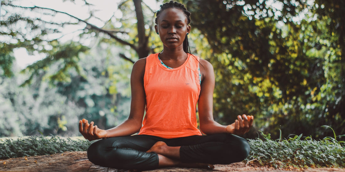 Woman doing yoga in nature to improve her gut health