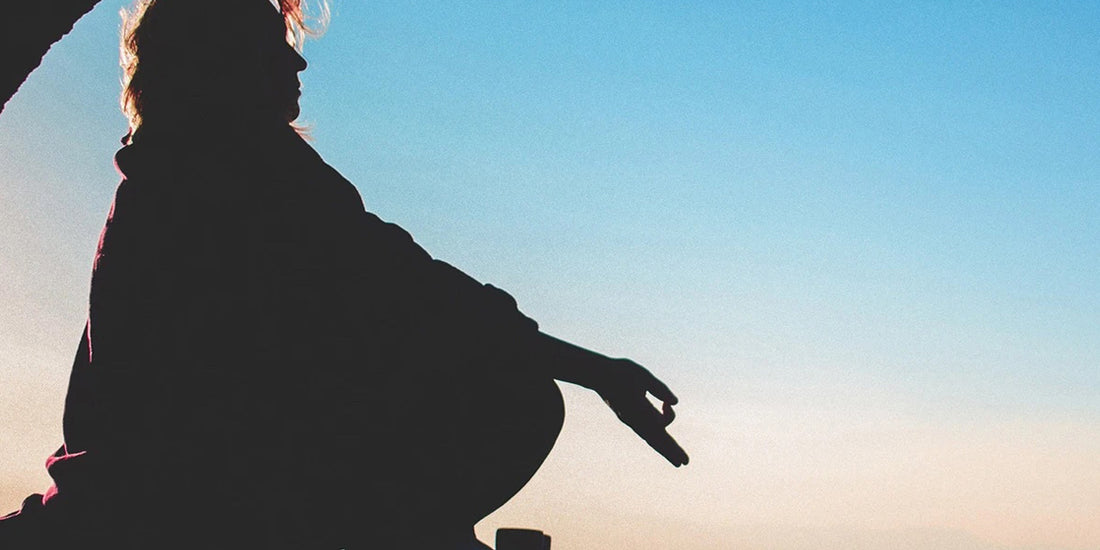 Woman meditating to reduce stress and boost her immune system