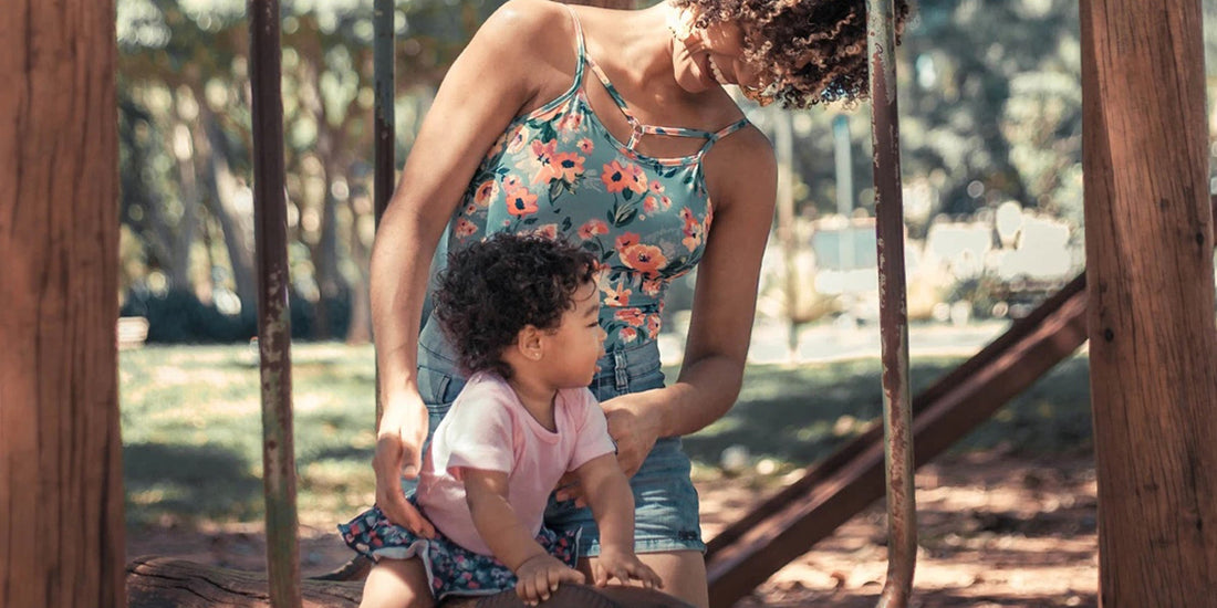 Woman and baby playing at the park