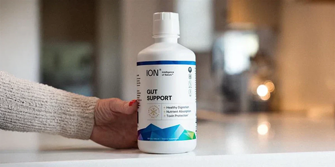 hand holding bottle of ION Gut Support