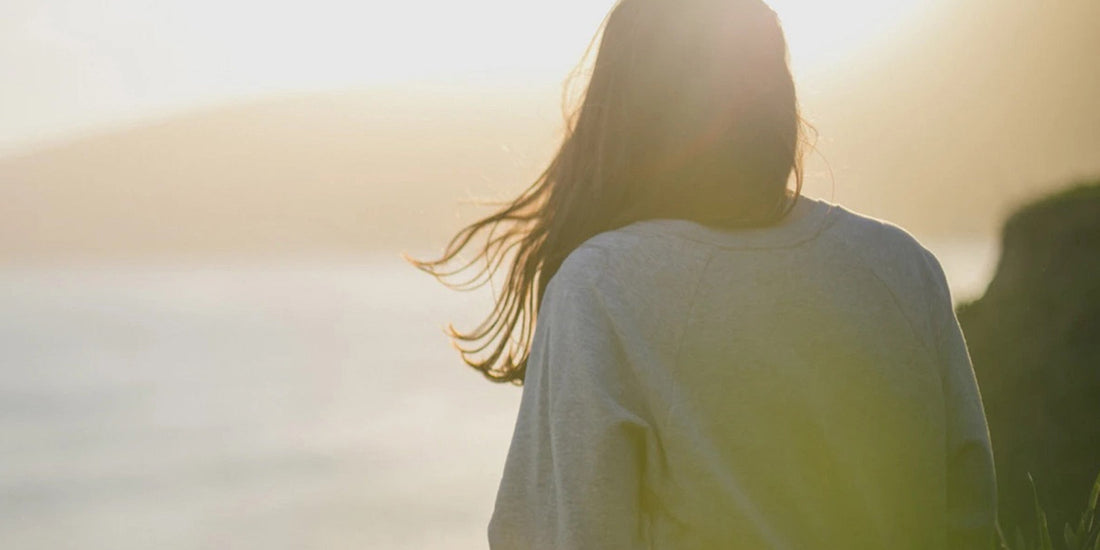 Woman looking out over the sunset