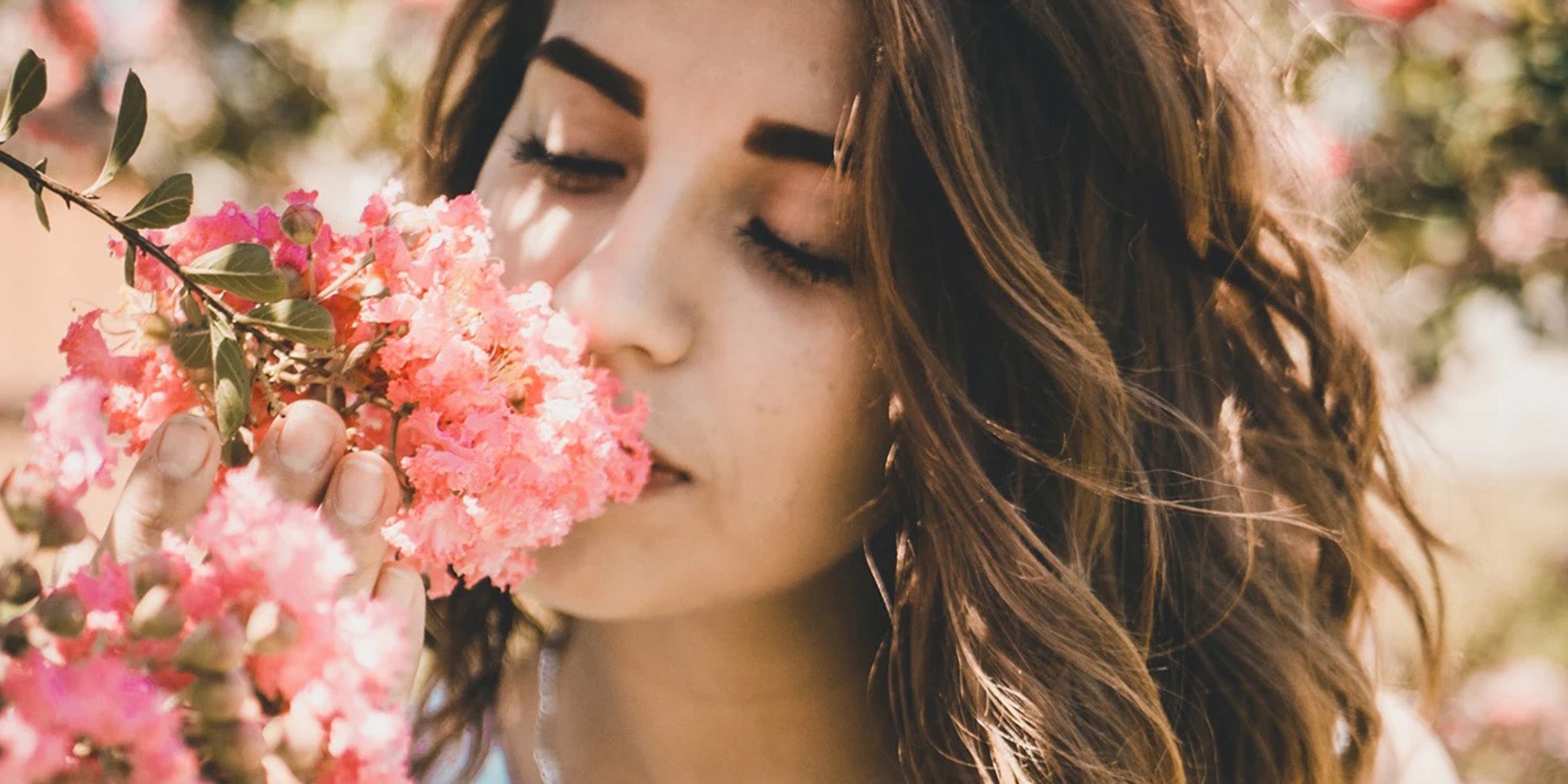 Woman smelling flowers outside