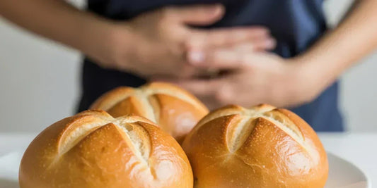 Woman holding stomach and loaves of bread