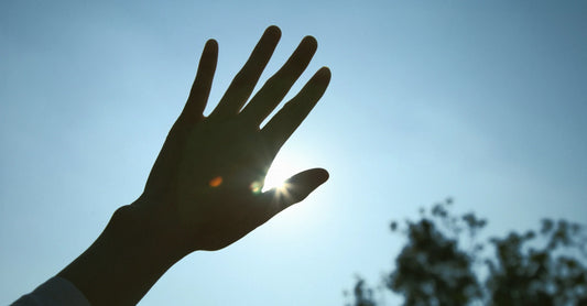 hand covering the sun