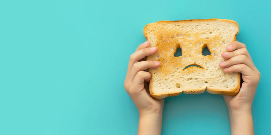 Image of bread with a frown representing issues with gluten