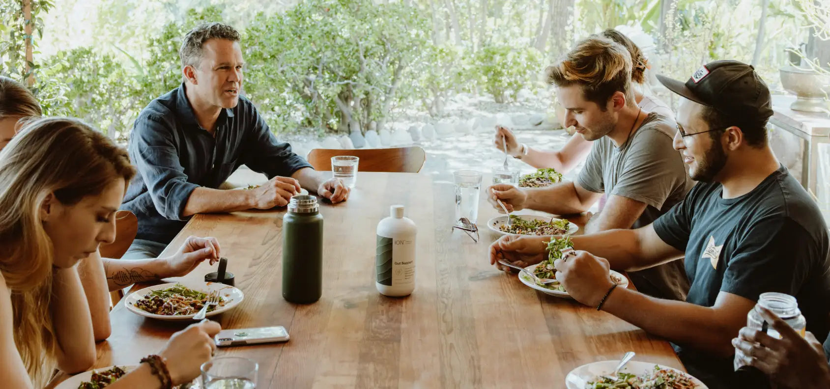 Dr. Zach Bush chatting with people at the dinner table